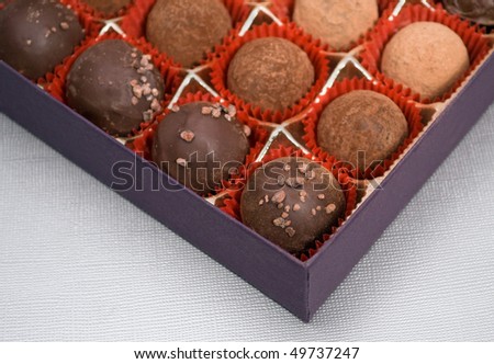 chocolate truffles in gift box, focus on foreground truffle