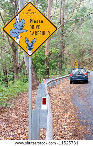 Warning street sign and a car in Australia