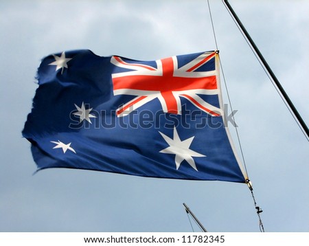 An Australian flag waves on a ships mast
