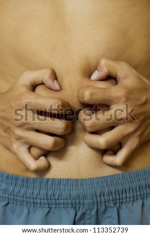Young man with problems stomach ache. To be treated.