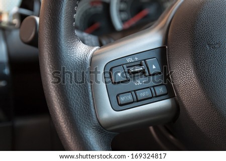 Audio control buttons on the steering wheel of car