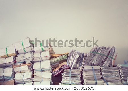 Stack of business report paper files on the document racks,in vintage style