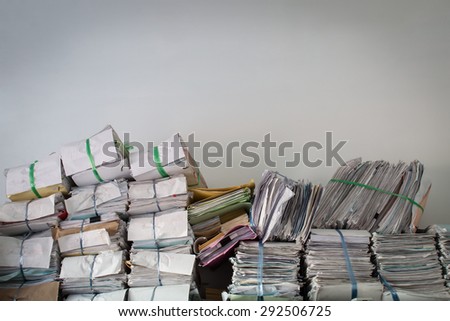 Stack of business report paper files on the document racks