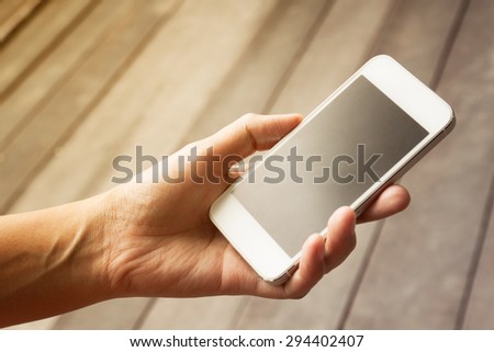 lose up of a woman using mobile smart phone,in vintage style
