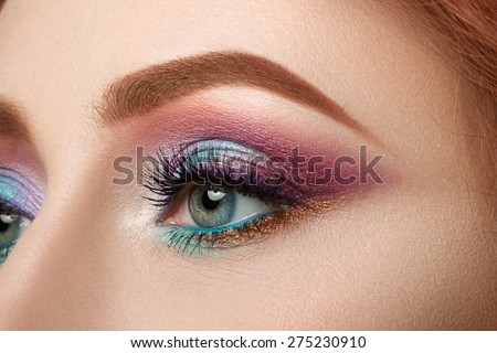 Close-up view of female blue eye with beautiful make-up. Perfect Make-up closeup.