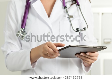 Female Doctor Holding Tablet PC. Doctor\'s hands close-up. Medical service and health care concept.