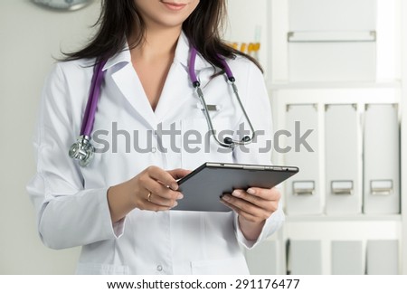 Female Doctor Holding Tablet PC. Doctor\'s hands close-up. Medical service and health care concept.