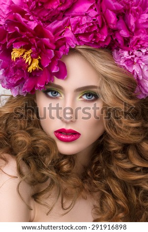 Close-up beauty portrait of young pretty girl with flower wreath in her hair wearing bright pink lipstick. Bright modern summer makeup. Beauty, spa and skincare concept