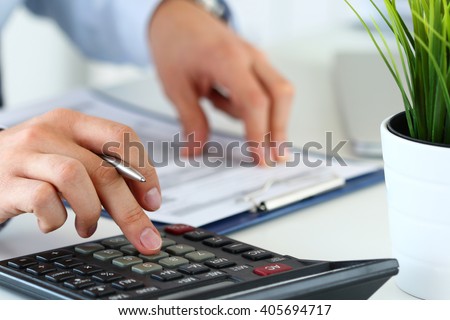 Close up view of bookkeeper or financial inspector hands  making report, calculating or checking balance. Home finances, investment, economy, saving money or insurance concept