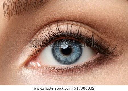 Close up view of beautiful blue female eye. Good vision, contact lenses, trust or observation concept