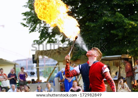 KRAKOW, POLAND - JUNE 21: St. John\'s Fair festival\'s fire show on June 21, 2013 in Krakow, Poland. In this performance the actors are fighting with the dragon