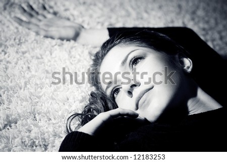 beautiful female lays on a white carpet