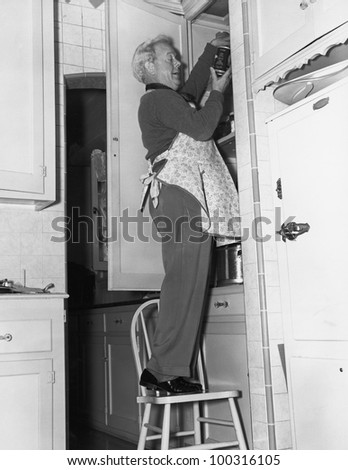 Man wearing apron in kitchen
