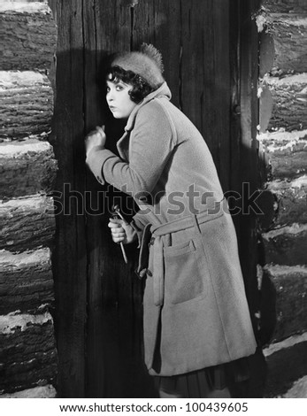 Woman knocking on cabin door