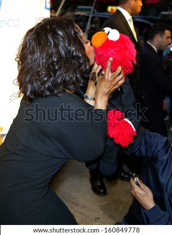 TV Host Oprah Winfrey and friend Elmo kiss at the Sesame Workshop\'s Second Annual Benefit Gala at Cipriani\'s 42nd St June 2, 2004 in New York City