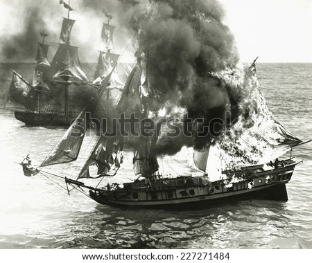 Burning boat in the middle of the ocean