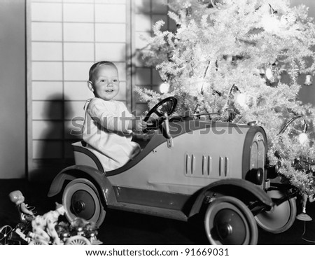 stock-photo-child-with-toy-car-under-christmas-tree-91669031.jpg