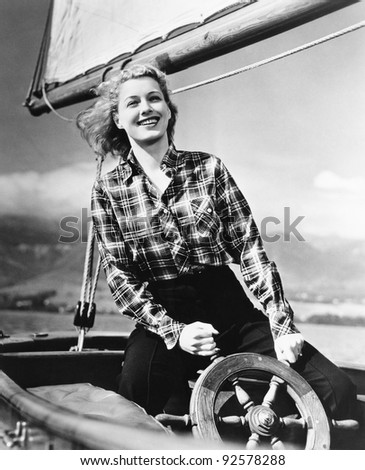 http://image.shutterstock.com/display_pic_with_logo/921176/921176,1325275320,60/stock-photo-young-woman-standing-at-the-helm-of-a-sailboat-and-holding-the-wheel-92578288.jpg