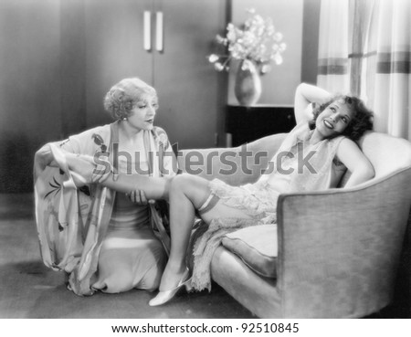 One woman massaging a friends leg