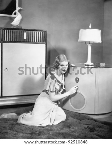 Woman sitting on the floor listening to her radio