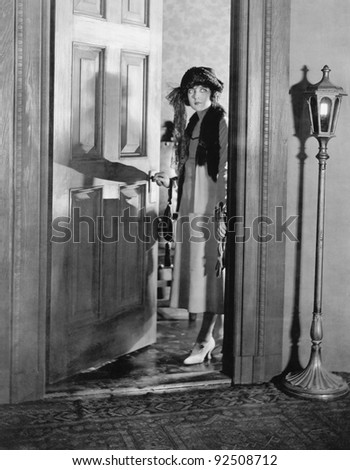 Woman dressed up standing in the doorway