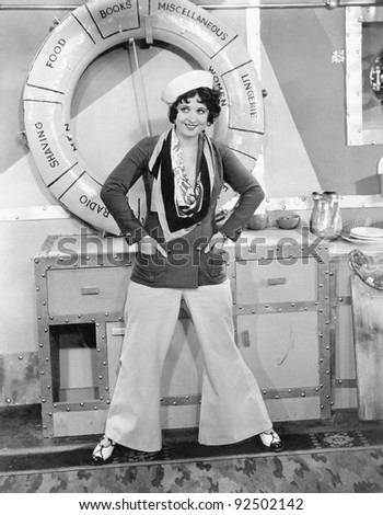 Woman in a sailors outfit in front of a life preserver