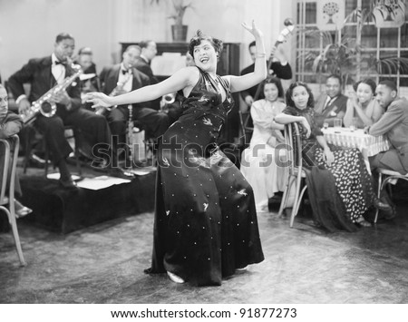 stock photo Zaftig woman performing a dance in front of a group of people