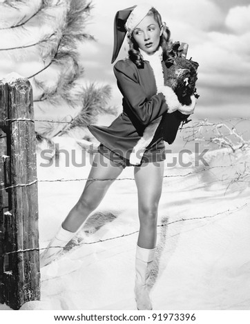 Woman in a Santa costume getting caught on a barbed wire fence