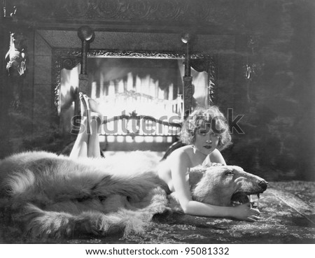 Portrait of woman on bear rug with fireplace