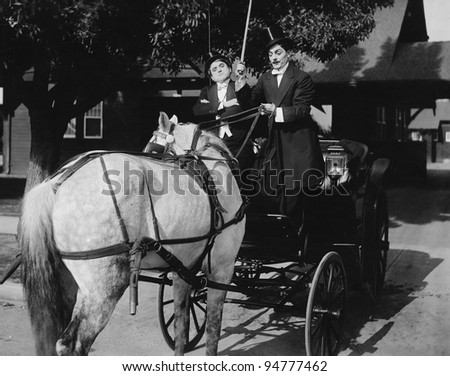 Gentlemen driving carriage with horse hitched backwards