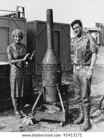Mud covered couple with portable stove