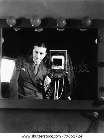 Portrait of a man standing with a large format camera