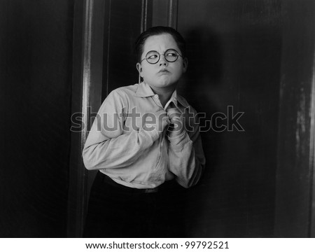 Boy trying to listen putting his ear at a door