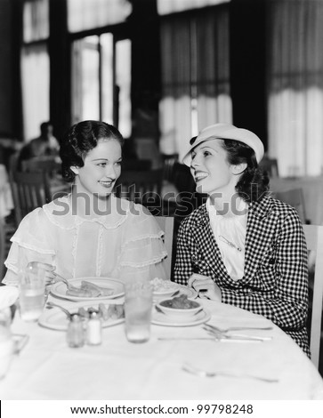 Two women sitting together in a restaurant