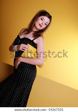 Beautiful Happy Fashion Woman holding Yellow Purse