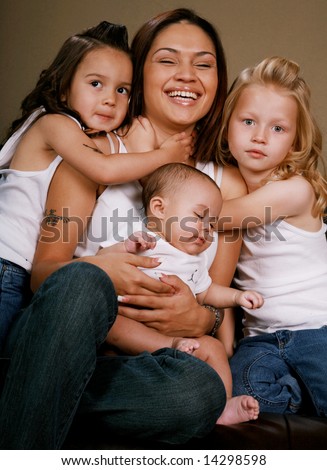Beautiful and Happy Mother Surrounded by her three daughters