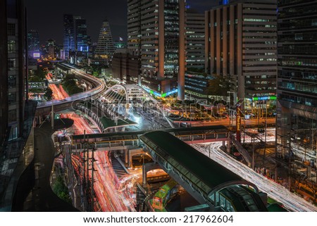 SATHORN ROAD, BANGKOK - September 15, 2014: High buildings and a sky walk at Sathorn-Narathiwas intersection in Bangkok, Thailand. Sky walk is the connecting walkway between sky train and rapid bus.