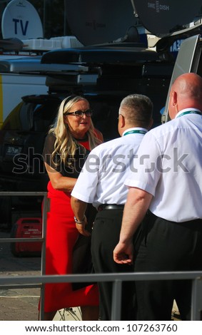 MOSCOW, RUSSIA - JUNE 21: Tatiana Mikhalkova talking to security staff at XXXIV Moscow International Film Festival opening ceremony. Taken on June 21, 2012 in Moscow, Russia.
