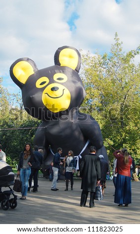 MOSCOW, RUSSIA - SEPTEMBER 01: People in Gorky park near 1980 olympic games symbol model - bear in conjunction with Moscow 865th birthday on September 01, 2012 in Moscow, Russia..