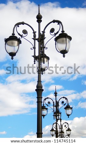 Vintage street light, blue sky clouds.