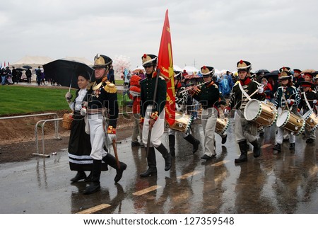 MOSCOW REGION - SEPTEMBER 02: Unknown soldiers of different ages walking  in the rain. Borodino historical reenactment. Taken on September 02, 2012 in Borodino, Moscow Region, Russia.