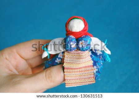 A doll without face made according to old Russian samples. It's made of different colorful fabric pieces.