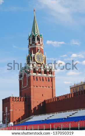MOSCOW, RUSSIA - MAY 01: Spasskaya (Savior) clock tower and holiday tribunes in colors of Russian flag on the Red Square put there for May holidays celebration. Taken on May 01, 2013 in Moscow.
