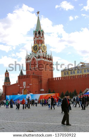 MOSCOW, RUSSIA - MAY 01: People walking on the Red Square decorated for May holidays. Spasskaya clock-tower. Spring and Labor Day celebration on May 01, 2013 in Moscow, Russia.