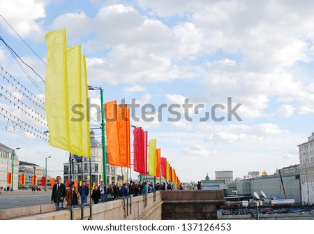 MOSCOW, RUSSIA - MAY 01: People walking on the bridge decorated for 1st of May holiday. Spring and Labor Day (Workers\' Day)  celebration on May 01, 2013 in Moscow, Russia.