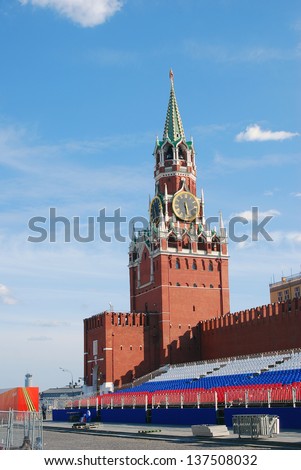 MOSCOW, RUSSIA - MAY 01: Spasskaya (Savior) clock tower and holiday tribunes in colors of Russian flag on the Red Square put there for May holidays celebration. Taken on May 01, 2013 in Moscow.