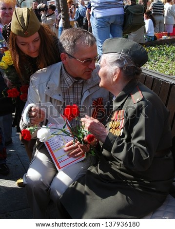 MOSCOW, RUSSIA - MAY 09: A war veteran holding flowers. Victory Day celebration on May 09, 2013 in Moscow.