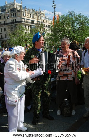 MOSCOW, RUSSIA - MAY 09: People sing songs and play accordion. Victory Day celebration on May 09, 2013 in Moscow.