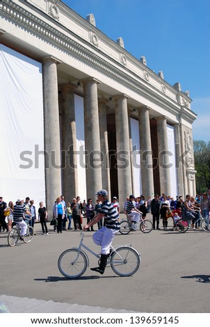 MOSCOW, RUSSIA - MAY 09: Young actor rides a bicycle, he performs in the Gorky park. Victory Day celebration on May 09, 2013 in Moscow.