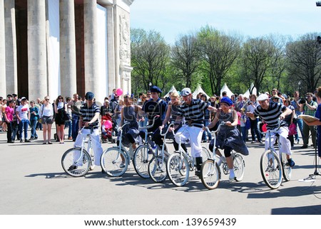 MOSCOW, RUSSIA - MAY 09: Young actors ride bicycles, they perform in the Gorky park. Victory Day celebration on May 09, 2013 in Moscow.